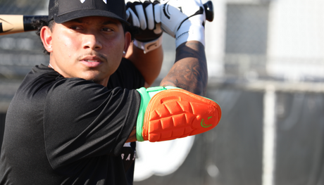 baseball player wearing protective elbow guard at bat